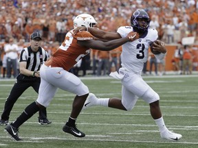 TCU quarterback Shawn Robinson (3) is sacked for a loss by Texas linebacker Jeffrey McCulloch (23) during the first half of an NCAA college football game, Saturday, Sept. 22, 2018, in Austin, Texas.