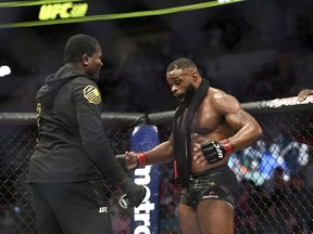 Tyron Woodley, right, reacts after defeating Darren Till by submission in their welterweight title mixed martial arts bout at UFC 228 on Saturday, Sept. 8, 2018, in Dallas.