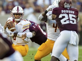 Texas A&M defensive back Donovan Wilson, center, sacks Louisiana Monroe quarterback Caleb Evans, left, for a loss during the first quarter of an NCAA college football game Saturday, Sept. 15, 2018, in College Station, Texas.