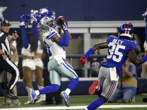 Dallas Cowboys wide receiver Tavon Austin (10) pulls in a pass in front of New York Giants cornerback Curtis Riley (35) to score a 64-yard touchdown during the first half of an NFL football game in Arlington, Texas, Sunday, Sept. 16, 2018.