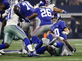 New York Giants quarterback Eli Manning (10) is sacked for a loss by Dallas Cowboys defensive end Demarcus Lawrence (90) during the first half of an NFL football game in Arlington, Texas, Sunday, Sept. 16, 2018.
