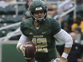 Baylor quarterback Charlie Brewer (12) rolls out of the pocket against Kansas during the first half of an NCAA college football game, Saturday, Sept. 22, 2018, in Waco, Texas.