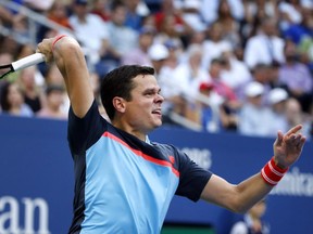 Milos Raonic of Canada returns a shot to John Isner of the United States, during the fourth round of the U.S. Open tennis tournament, Sunday, Sept. 2, 2018, in New York.