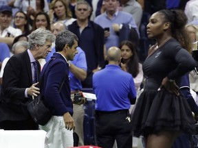Chair umpire Carlos Ramos, second from left, is lead off the court by referee Brian Earley after Naomi Osaka, of Japan, defeated Serena Williams in the women's final of the U.S. Open tennis tournament, Saturday, Sept. 8, 2018, in New York.