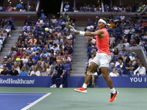 Rafael Nadal, of Spain, returns a shot to Karen Khachanov, of Russia, during the third round of the U.S. Open tennis tournament, Friday, Aug. 31, 2018, in New York.