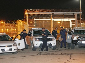 Correctional officers gather outside a gate at the Utah State Correctional Facility Wednesday, Sept. 19, 2018, in Draper, Utah. Wanda Barzee, a woman who helped kidnap Elizabeth Smart when she was a teenager and stood by as the girl was sexually assaulted, was released from prison Wednesday after 15 years in custody. Barzee, 72, left the Utah state prison in the Salt Lake City suburb of Draper, spokeswoman Kaitlin Felsted said in a statement that did not provide details about Barzee's destination.