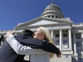 Elizabeth Smart receives a hug before speaking at a news conference Thursday, Sept. 13, 2018, in Salt Lake City. Smart says it appears there is no viable, legal recourse she can take to stop the release of one of her kidnappers. Smart said that she only found out about 72-year-old Wanda Barzee's release shortly before the public did.