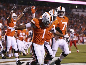 Virginia tailback Jordan Ellis (1) celebrates a touchdown with his teammates in the first half of an NCAA college football game against Richmond, Saturday, Sept. 1, 2018, in Charlottesville, Va.