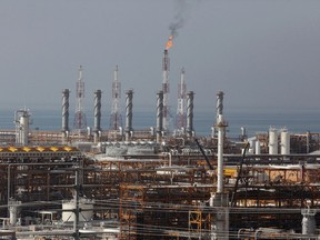 FILE - In this Jan. 22, 2014, file photo, a partially constructed gas refinery at the South Pars gas field is seen on the northern coast of Persian Gulf in Asalouyeh, Iran. Iran likely will further embrace Beijing as an alternative market for its crude oil and financial transactions amid uncertainty over the nuclear deal. That doesn't mean China offers a safe haven to Iran without conditions. Analysts say Beijing will try to extract the maximum benefit, and there is growing concern that China may take advantage of Iran.