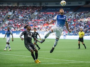 FC Dallas' Cristian Colman, front right, gets his head on the ball above Vancouver Whitecaps' Yordy Reyna during the second half of an MLS soccer game in Vancouver, on Sunday September 23, 2018.