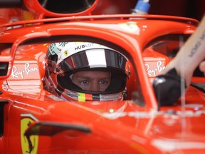 Ferrari driver Sebastian Vettel of Germany has his car attended prior to a free practice session at the Sochi Autodrom circuit in Sochi, Russia, Friday, Sept. 28, 2018. The 2018 Formula One Grand Prix of Russia will take place on Sunday, Sept. 30, 2018.