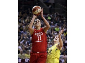 Washington Mystics' Elena Delle Donne (11) shoots as Seattle Storm's Breanna Stewart defends during the first half of Game 1 of the WNBA basketball finals Friday, Sept. 7, 2018, in Seattle.