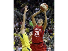 Washington Mystics' Kristi Toliver (20) shoots over Seattle Storm's Sue Bird in the first half of Game 2 of the WNBA basketball finals Sunday, Sept. 9, 2018, in Seattle.