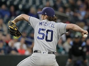 San Diego Padres starting pitcher Bryan Mitchell throws against the Seattle Mariners during the first inning of a baseball game, Tuesday, Sept. 11, 2018, in Seattle.