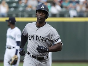 New York Yankees' Andrew McCutchen rounds the bases after he hit a solo home run during the first inning of a baseball game against the Seattle Mariners, Saturday, Sept. 8, 2018, in Seattle.