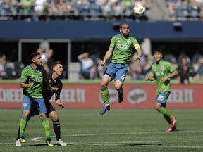 Seattle Sounders midfielder Osvaldo Alonso (6) heads the ball during the second half of an MLS soccer match against Sporting Kansas City, Saturday, Sept. 1, 2018, in Seattle. The Sounders won 3-1.