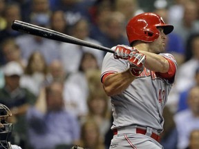 Cincinnati Reds' Scott Schebler watches his RBI-double during the fourth inning of a baseball game against the Milwaukee Brewers on Tuesday, Sept. 18, 2018, in Milwaukee.