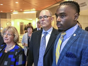 FILE - In this Aug. 23, 2018, file photo, University of Wisconsin wide receiver Quintez Cephus, right, with his attorneys Kathleen Stalling, left, and Stephen Meyer after appear in court in Madison, Wis. Prosecutors have charged Cephus with second- and third-degree sexual assault. Cephus is scheduled to appear in court Tuesday, Sept. 11, 2018, for a preliminary hearing, during which a judge is expected to decide whether the case is strong enough to proceed to trial.