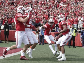 Wisconsin's Jonathan Taylor is congratulated after running for a touchdown during the first half of an NCAA college football game against New Mexico Saturday, Sept. 8, 2018, in Madison, Wis.