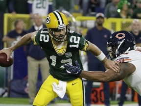 Green Bay Packers' Aaron Rodgers gets away from Chicago Bears' Akiem Hicks during the first half of an NFL football game Sunday, Sept. 9, 2018, in Green Bay, Wis.