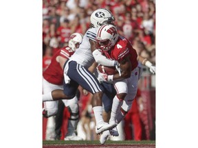 Wisconsin's A.J. Taylor catches a pass in front of BYU's Dayan Ghanwoloku during the first half of an NCAA college football game Saturday, Sept. 15, 2018, in Madison, Wis.