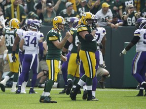 Green Bay Packers' Aaron Rodgers celebrates a touchdown pass to Davante Adams during the first half of an NFL football game against the Minnesota Vikings Sunday, Sept. 16, 2018, in Green Bay, Wis.