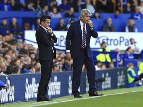 Everton manager Marco Silva, left, and West Ham United manager Manuel Pellegrini look on from the sidelines during their English Premier League soccer match at Goodison Park in Liverpool, England, Sunday Sept. 16, 2018.