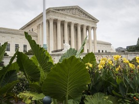 In this Sept. 21, 2018, photo, the Supreme Court is seen in Washington. On Monday, the court will begin its new term with the crack of the marshal's gavel and not a camera in sight.