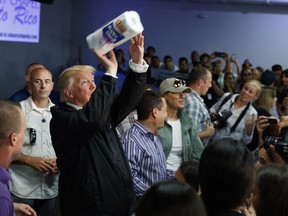 FILE - In this Oct. 3, 2017 file photo, President Donald Trump tosses paper towels into a crowd at Calvary Chapel in Guaynabo, Puerto Rico.
