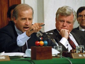 FILE - In this Oct. 12, 1991, file photo, then-Senate Judiciary Committee Chairman Sen. Joe Biden, D-Del., points angrily at Clarence Thomas during comments at the end of hearings on Thomas' nomination to the Supreme Court on Capitol Hill. Sen. Edward Kennedy, D-Mass., watches at right.