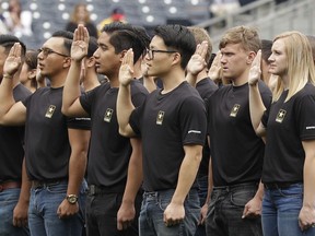 FILE - In this June 4, 2017, file photo. nNew Army recruits take part in a swearing in ceremony before a baseball game between the San Diego Padres and the Colorado Rockies in San Diego. The Army has missed its recruiting goal for the first time in more than a decade. Army leaders tell The Associated Press they signed up about 70,000 new troops for the fiscal year that ends Sept. 30, 2018.