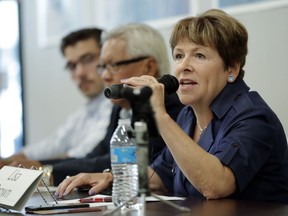 FILE - In this July 17, 2018, photo, Lisa Brown, the Democratic opponent to Rep. Cathy McMorris Rodgers, R-Wash., speaks during a candidates forum in Colfax, Wash. Some Democratic candidates are determined not to let Republican members of Congress distance themselves from the president's trade policies. Their efforts play into voter concerns that Congress should be more of a check on Trump. Republicans hope that a strong economy carries them to victory.