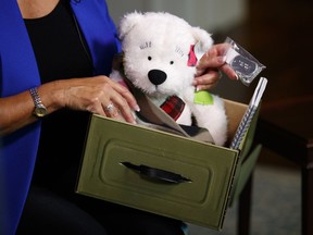 Karen Pence holds a Comfort Crew Kit to be given to a military child during an interview with The Associated Press at the Vice President's residence, the Naval Observatory, in Washington, Monday, Sept. 10, 2018.  "Now people take my phone calls," Karen Pence told The Associated Press in an interview. These days, Vice President Mike Pence's wife is using her new cachet to call around on behalf of military spouses, looking to help them overcome the challenges that come with being wed to an active-duty service member.