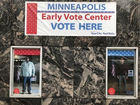 An "Early Vote Center" sign and "I Will Vote" signs on Thursday, Sept. 20, 2018, mark a polling place in downtown Minneapolis that will open Friday as early voting begins in Minnesota. Minnesota and South Dakota are tied for the earliest start in the country for early voting in the 2018 midterm elections.