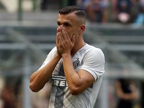 Inter Milan's Ivan Perisic touches his face after missing a scoring chance during the Serie A Soccer match between Inter Milan and Parma at the Milan San Siro stadium, Italy, Saturday, Sept. 15, 2018.