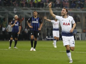 Tottenham midfielder Christian Eriksen, right, celebrates after he scored his side's first goal during the Champions League, group B soccer match between Inter Milan and Tottenham Hotspur, at the Milan San Siro Stadium, Italy, Tuesday, Sept. 18, 2018.