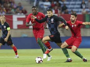 Croatia's Mateo Kovacic vies for the ball with Portugal's Ruben Neves, right, during the international friendly soccer match between Portugal and Croatia at the Algarve stadium, outside Faro, Portugal, Thursday, Sept. 6, 2018.