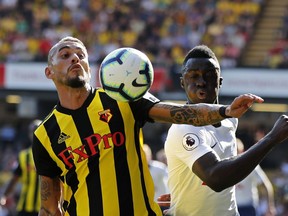 Tottenham's Davinson Sanchez, right, vies for the ball with Watford's Roberto Pereyra during the English Premier League soccer match between Watford FC and Tottenham Hotspur at Vicarage Road stadium in Watford, England, Sunday, Sept 2, 2018.