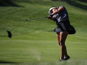 Maria Torres of Puerto Rico takes a divot on the 1st hole during the third round of the Evian Championship women's golf tournament in Evian, eastern France, Saturday, Sept. 15, 2018.