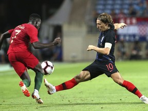 Croatia's Luka Modric, right, vies for the ball with Portugal's Bruma during the international friendly soccer match between Portugal and Croatia at the Algarve stadium, outside Faro, Portugal, Thursday, Sept. 6, 2018.