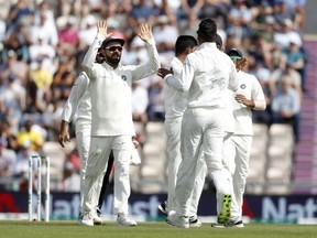 India's Virat Kohli, left celebrates with teammates after India's Jasprit Bumrah takes the wicket of England's Alastair Cook during play on the third day of the 4th cricket test match between England and India at the Ageas Bowl in Southampton, England, Saturday, Sept. 1, 2018. England and India are playing a 5 test series.