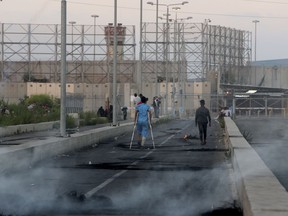 Palestinians stand in front of the Erez crossing to Israel between Gaza and Israel, in the northern Gaza Strip, during a protest Tuesday, Sept. 18, 2018. Gaza's Health Ministry says two Palestinians were killed by Israeli fire at a protest near a crossing point between the enclave and Israel.