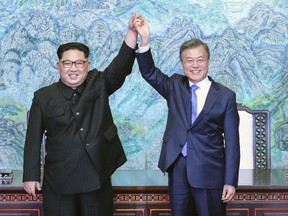 FILE - In this April 27, 2018 file photo, North Korean leader Kim Jong Un, left, and South Korean President Moon Jae-in raise their hands after signing a joint statement at the border village of Panmunjom in the Demilitarized Zone, South Korea. President Moon faces his toughest challenge yet in his third summit with Kim in Pyongyang, where he will be pressed to deliver substantive agreements beyond the vague aspirational statements on denuclearization that have been repeated in past months. (Korea Summit Press Pool via AP, File)