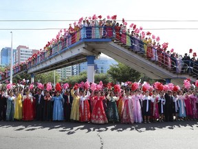 North Koreans fill the streets of Pyongyang to welcome South Korean President Moon Jae-in and the North Korean leader Kim Jong Un passing by during a car parade in North Korea, Tuesday, Sept. 18, 2018. (Pyongyang Press Corps Pool via AP)