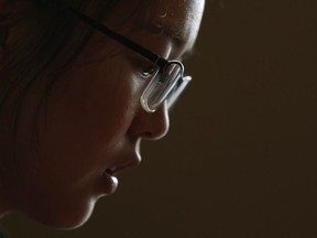 In this July 3, 2018, photo, Ren Liping pauses during an interview after filing her petition to have her rape allegation case reexamined in Beijing. Chinese graduate student Ren has spent the past year filing lawsuits and attempting to protest authorities in the coastal city of Qingdao for what she says was their mishandling of her rape allegation. At every turn, Ren has been stymied by guards. Her efforts highlight at once the challenges of reporting sexual assault in China and the determination of a new generation of Chinese women pushing the country into its own #MeToo moment despite all attempts to silence them.