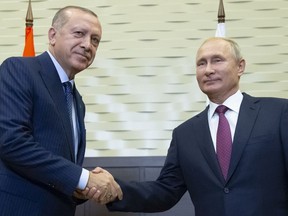 Russian President Vladimir Putin, right, and Turkish President Recep Tayyip Erdogan shake hands during their meeting in the Bocharov Ruchei residence in the Black Sea resort of Sochi in Sochi, Russia, Monday, Sept. 17, 2018. The presidents of Russia and Turkey are meeting in the Russian Black Sea resort of Sochi on Monday in a bid to find a diplomatic resolution to the crisis around a rebel-held region in Syria.