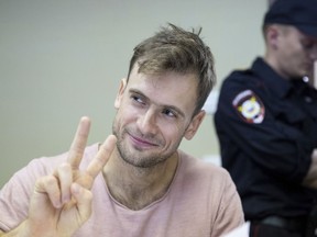 FILE In this file photo taken on Monday, July 23, 2018, Pyotr Verzilov, a member of the feminist protest group Pussy Riot, gestures during hearings in a court in Moscow, Russia. Russian news reports say Verzilov a member of Russian punk protest group Pussy Riot has been hospitalized in grave condition for what could be a possible poisoning.