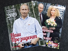 Two calendars showing the Russian leader are displayed in Moscow, Russia, Friday, Sept. 28, 2018. Salesmen say that annual calendars featuring the Russian leader are popular among tourists and Russian lawmakers.