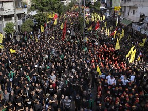 Muslim Shiites march during the holy day of Ashoura, in the southern suburbs of Beirut, Lebanon, Thursday, Sept 20, 2018. Ashoura is the annual Shiite commemoration of the death of Imam Hussein, the grandson of the Prophet Muhammad, at the Battle of Karbala in present-day Iraq in the 7th century.