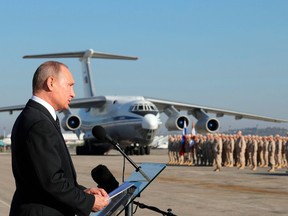 FILE - In this Dec. 12, 2017, file photo, Russian President Vladimir Putin addresses the troops at the Hemeimeem air base in Syria. When the presidents of Russia, Turkey and Iran meet in Tehran Friday, Sept. 7, all eyes will be on their diplomacy averting a bloodbath in Idlib, Syria's crowded northwestern province and last opposition stronghold. The three leaders whose nations are all under U.S. sanctions have an interest in working together, but Idlib is complicated and they have little common ground.